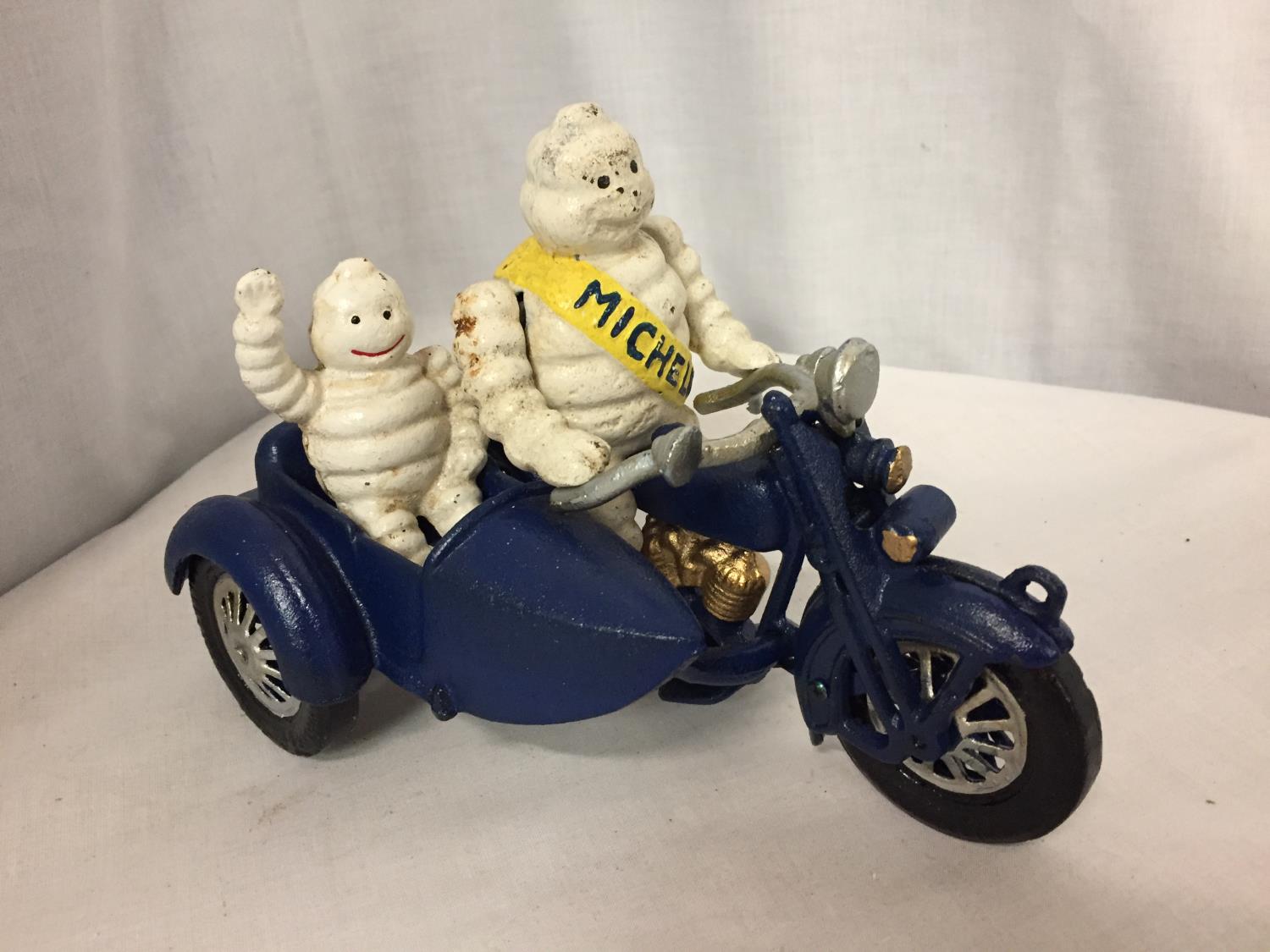 A CAST MICHELIN MAN ON A MOTOR BIKE