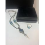 A SILVER NAVAJO NECKLACE WITH FEATHER DESIGN AND A SILVER RING WITH NAVAJO STONE WITH A PRESENTATION