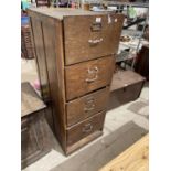 A MID CENTURY OAK FOUR DRAWER FILING CABINET