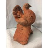 A TERRACOTTA ROOF TILE FINIAL OF A DOVE