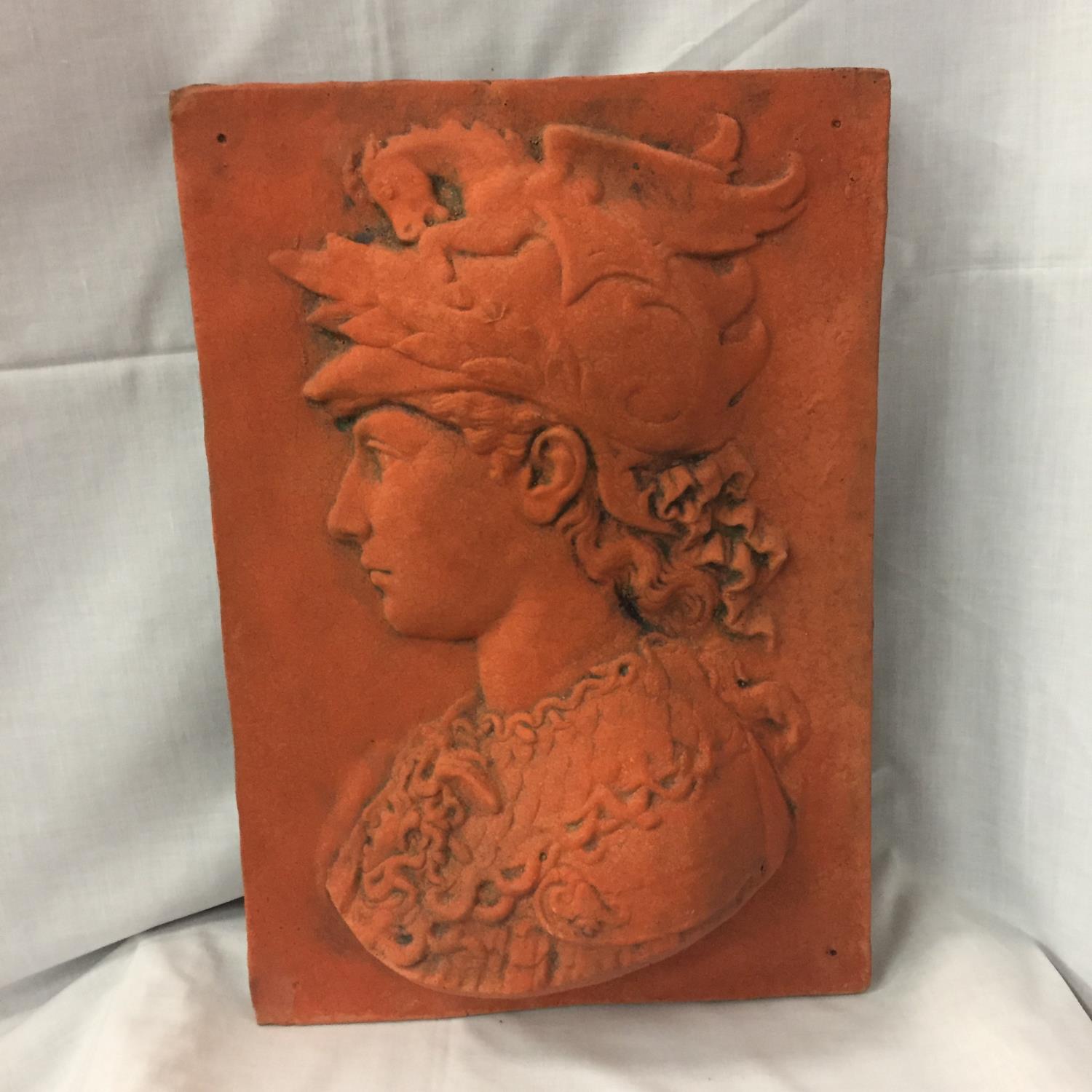 A TERRACOTTA WALL PLAQUE