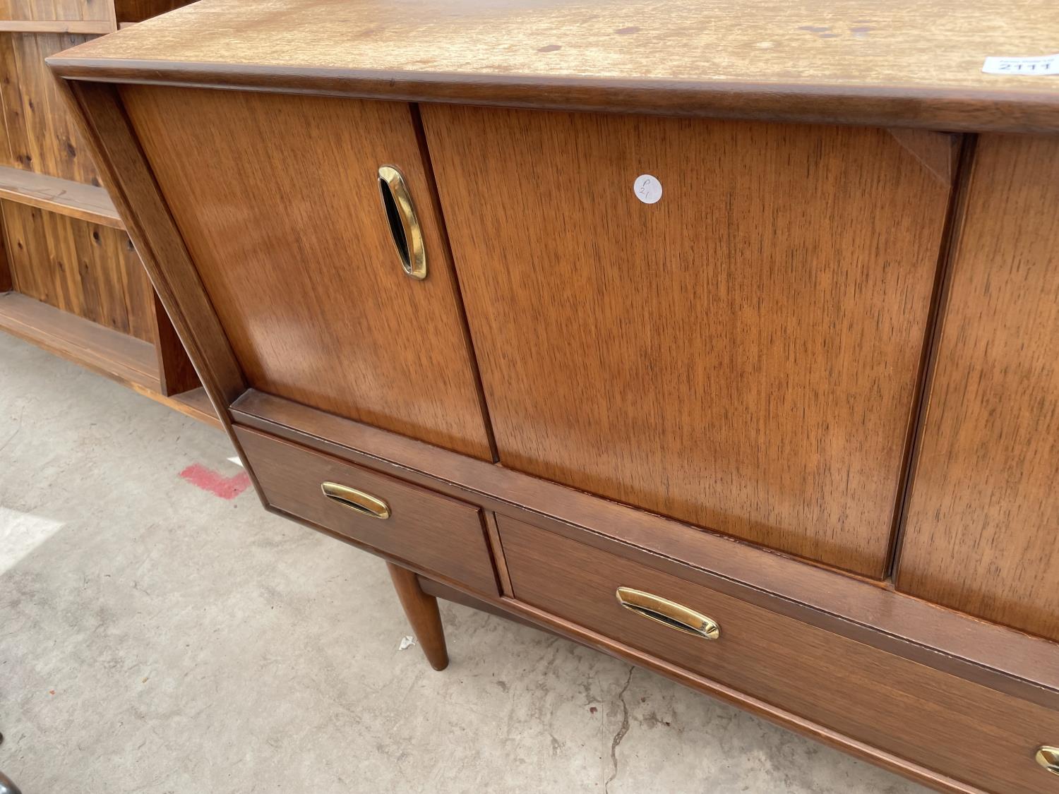 A RETRO TEAK G-PLAN SIDEBOARD ENCLOSING BI-FOLD DOORS AND THREE DRAWERS TO THE BASE, 57" WIDE - Image 4 of 7