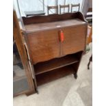 AN EARLY 20TH CENTURY OAK BUREAU WITH SHELVES TO THE BASE, 29" WIDE