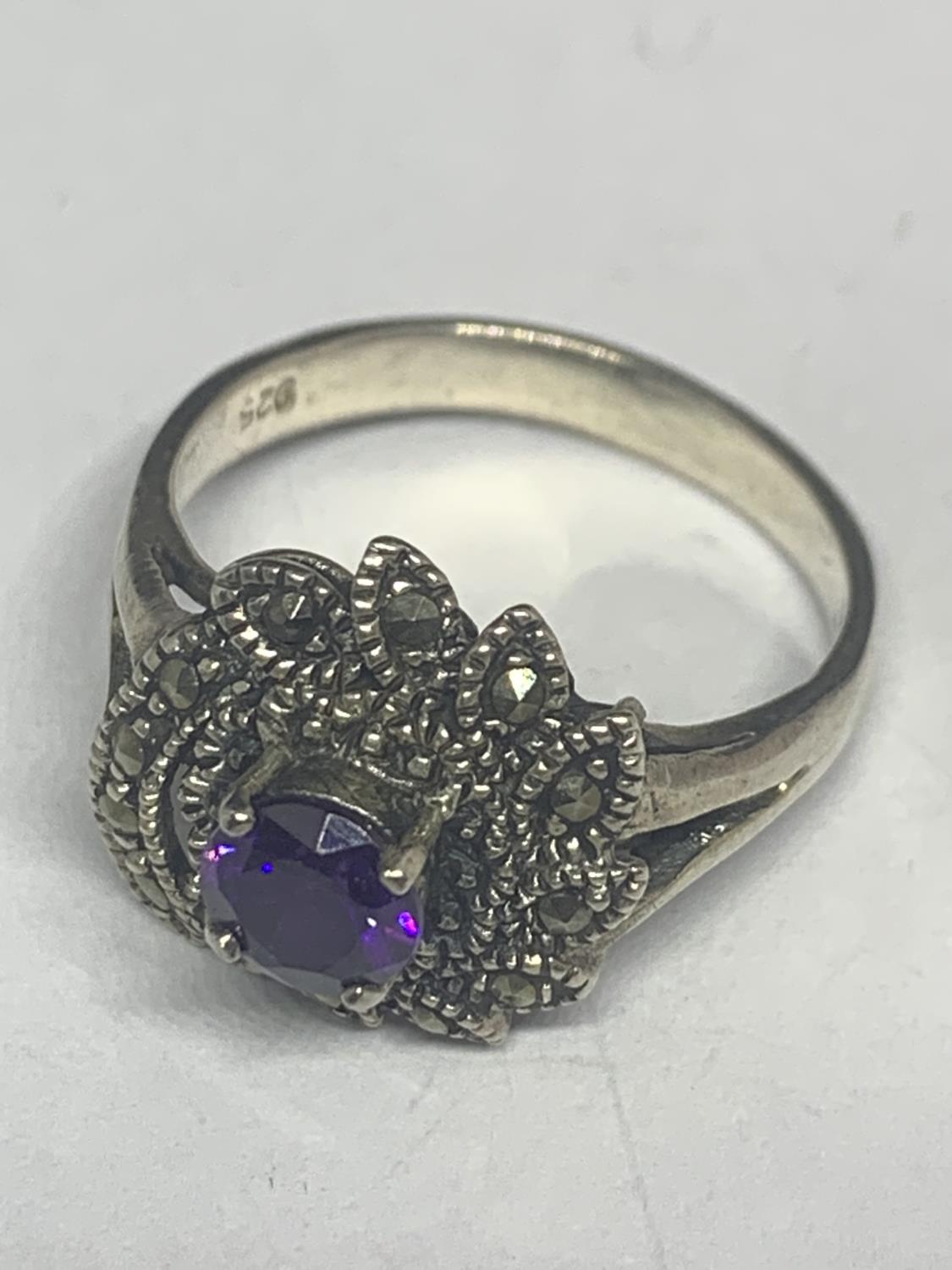 A SILVER MARCASITE AND PURPLE STONE RING WITH MATCHING EARRINGS IN A PRESENTATION BOX - Image 2 of 3