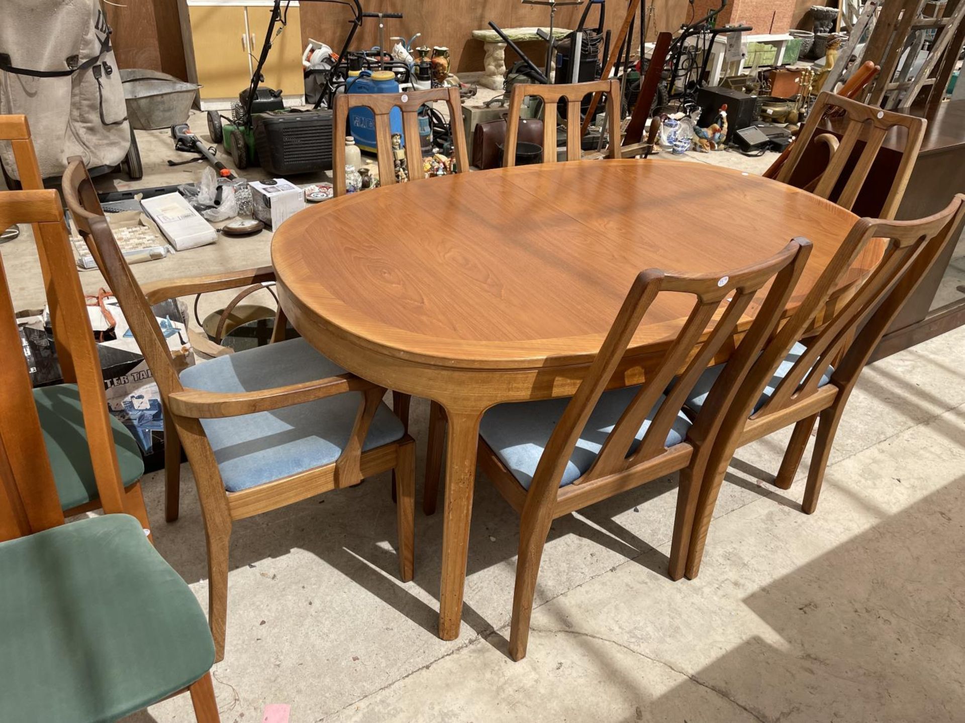 A NATHAN RETRO TEAK EXTENDING DINING TABLE WITH FOUR DINING CHAIRS AND TWO CARVERS