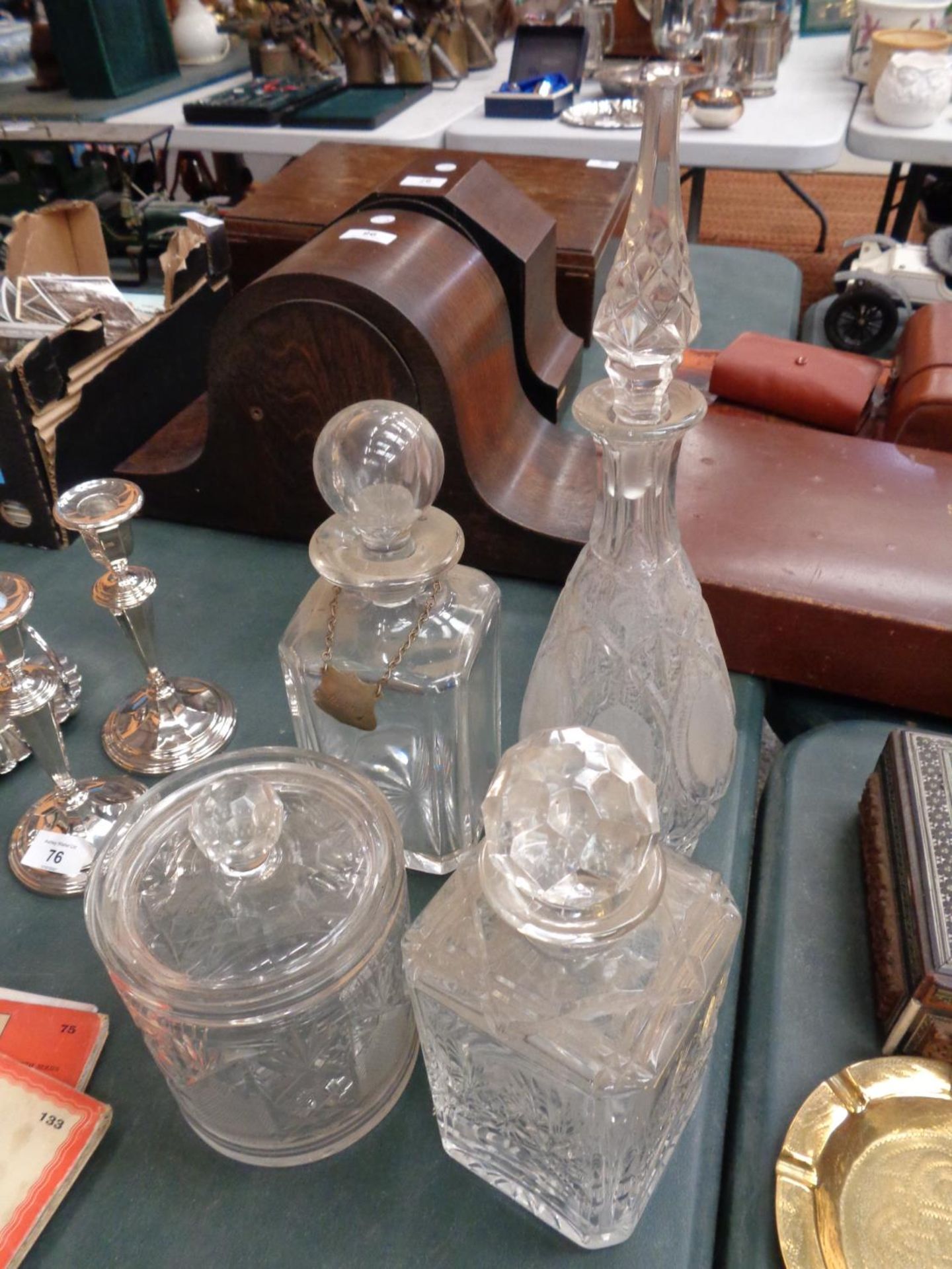 FOUR CUT GLASS DECANTERS ONE WITH LABEL