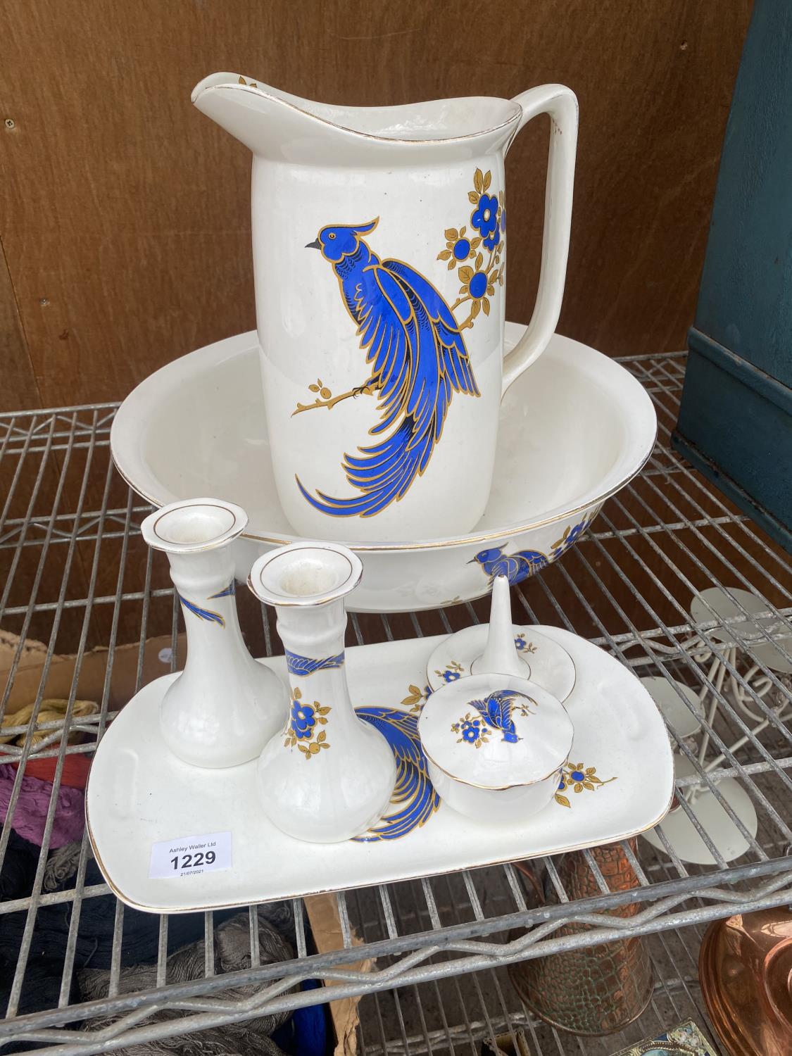 A LARGE WASH JUG AND BOWL AND A FURTHER DRESSING TABLE SET WITH BIRD DESIGN