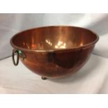 A TWIN HANDLED COPPER BOWL