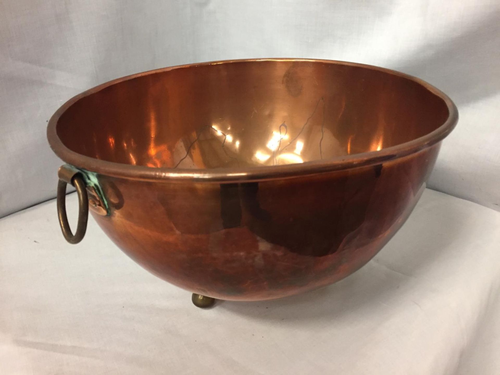 A TWIN HANDLED COPPER BOWL