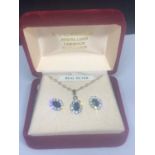 A BOXED SILVER NECKLACE AND EARRING SET WITH BLUE STONE CENTRES SURROUNDED BY CLEAR STONES