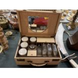 A VINTAGE CASED LADIES TRAVELLING CASEWITH BOTTLES AND JARS