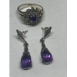 A SILVER MARCASITE AND PURPLE STONE RING WITH MATCHING EARRINGS IN A PRESENTATION BOX