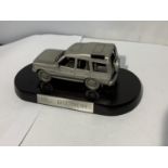 A PEWTER LAND ROVER DISCOVERY ON A PLINTH WITH A BOX