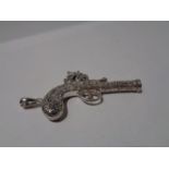 A PENDANT IN THE FORM OF AN ORNATE PISTOL