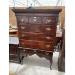 A GEORGE III OAK CHEST ON STAND, THE BASE ON FRONT CABRIOLE LEGS, WITH THREE DRAWERS, THE UPPER