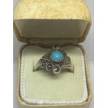 A SILVER RING WITH A BLUE NAVAJO STYLE STONE