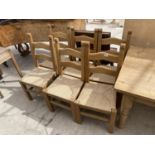 A SET OF SIX PINE LADDERBACK DINING CHAIRS WITH RUSH SEATS