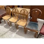 A VICTORIAN STYLE PINE HALL CHAIR AND THREE WHEELBACK DINING CHAIRS