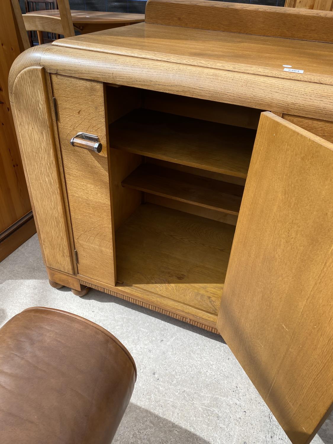 AN OAK E-GOMME SIDEBOARD DATED 1939 ENCLOSING CURVED END CUPBOARDS, TWO PAIRS OF CUPBOARDS WITH FOUR - Image 8 of 9