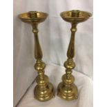 A PAIR OF TALL BRASS CANDLESTICKS HEIGHT 56CM