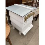 A FOUR TIER WHITE PAINTED FORMER BEEHIVE, DECORATED WITH BEES AND FLOWERS