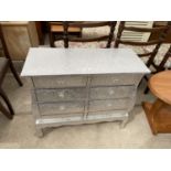 AN EMBOSSED SILVER COLOURED CHEST OF SIX DRAWERS WITH GLASS HANDLES, 31.5" WIDE