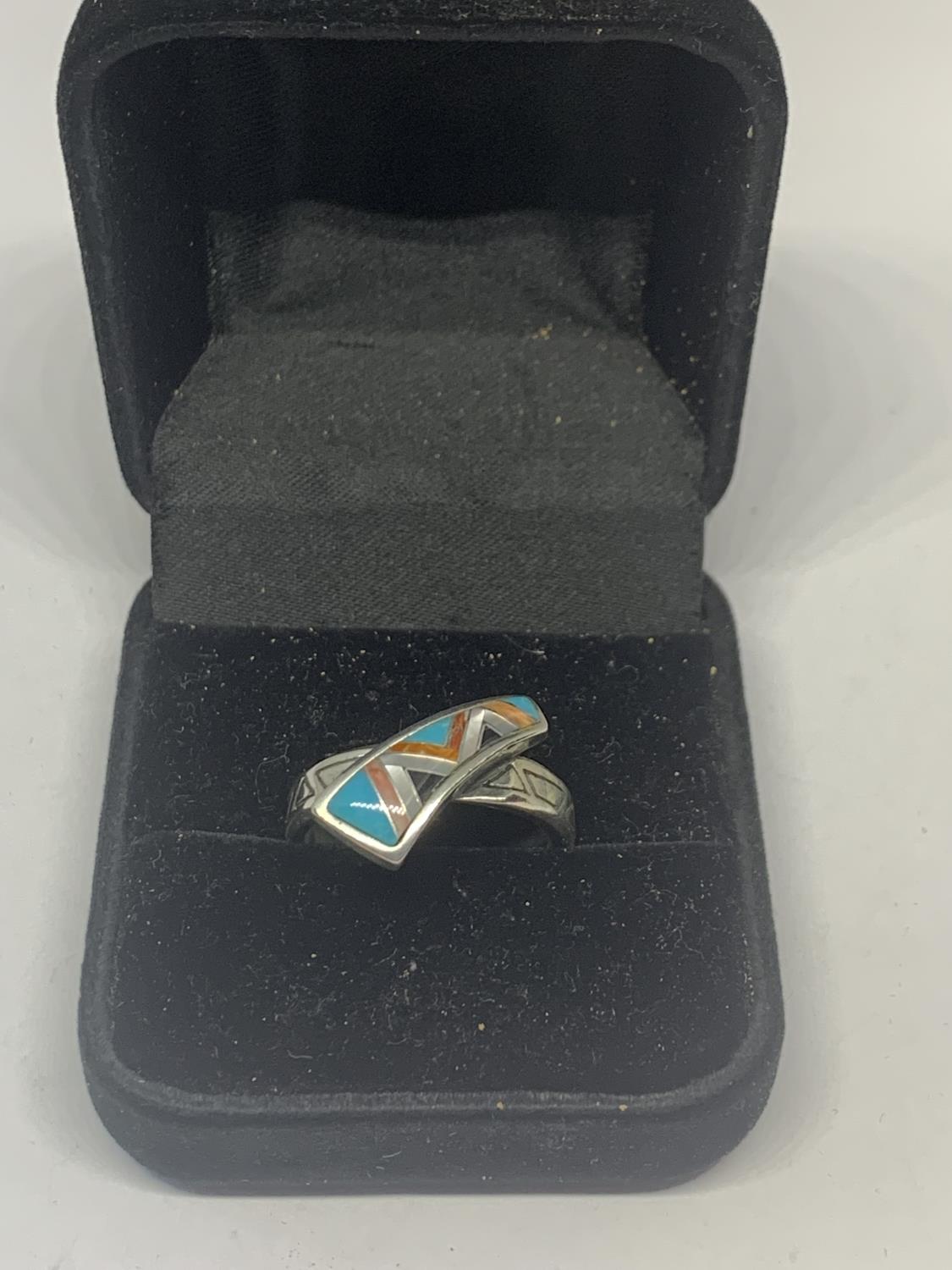 A SILVER RING WITH A NAVAJO STONE DESIGN IN A PRESENTATION BOX