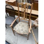 A SATINWOOD ARTS & CRAFTS LOW ELBOW CHAIR