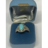 AN ORNATE SILVER RING WITH A BLUE NAVAJO STYLE STONE IN A PRESENTATION BOX