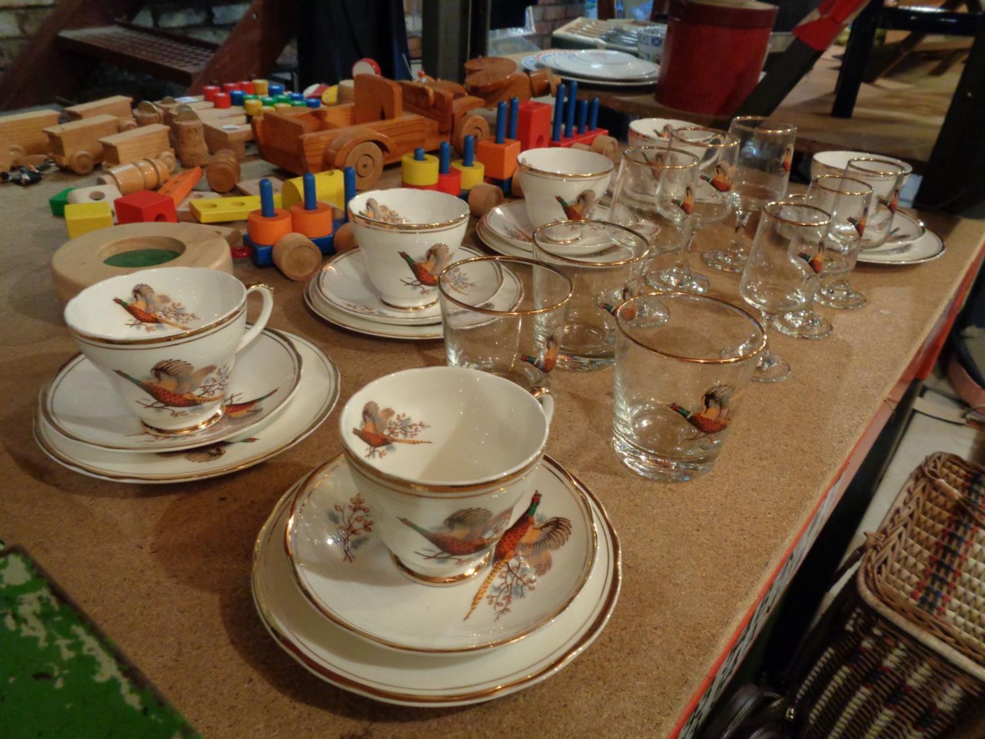 A SHERIDEN TEA SET OF SIX TRIOS AND MATCHING GLASSES IN A PHEASANT DESIGN