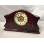 AN INLAID MAHOGANY MANTLE CLOCK WITH GILDED CENTRE FACE AND ENAMEL DIAL