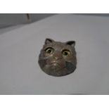 A CAT BROOCH WITH GLASS EYES