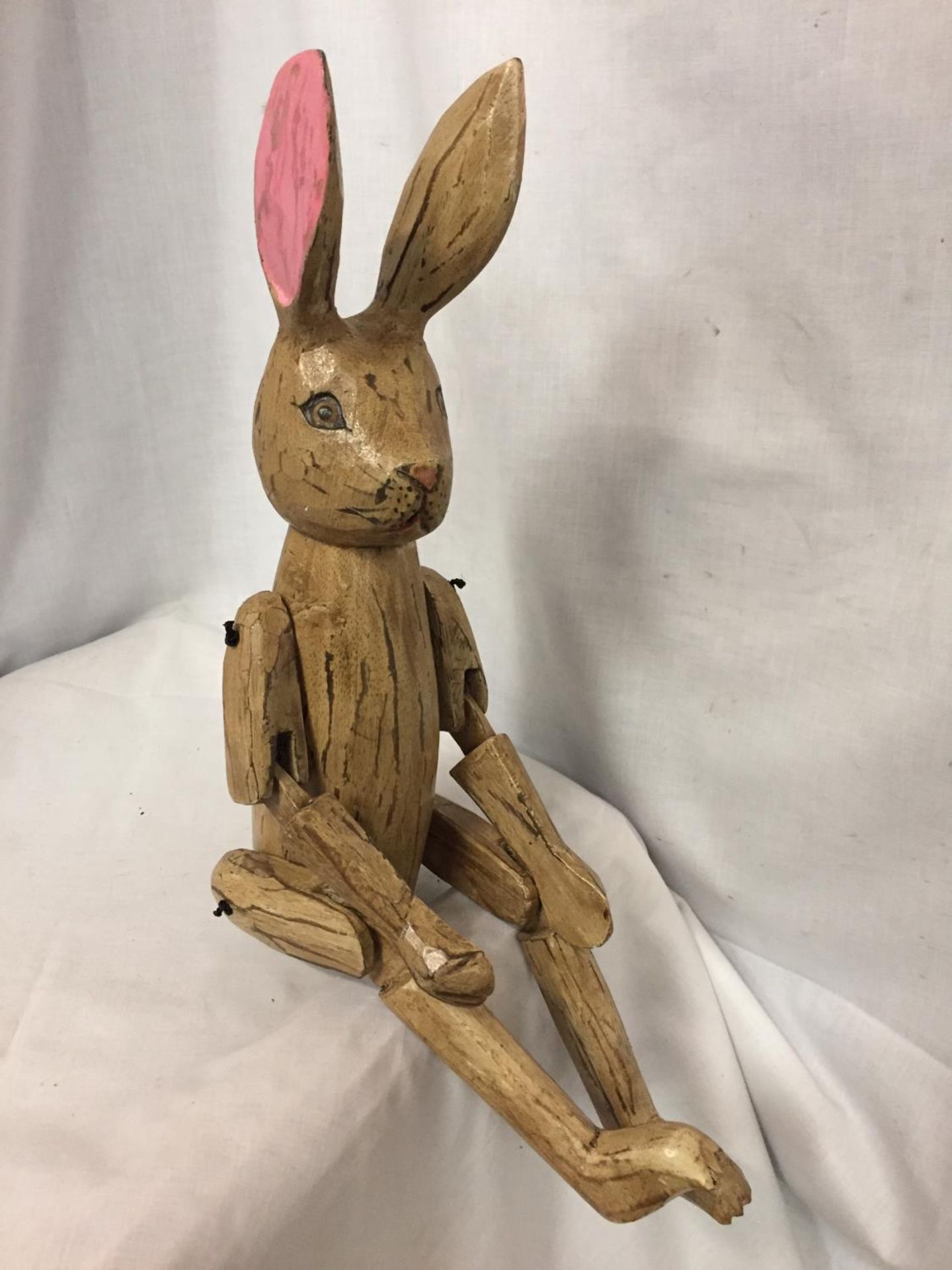 A WOODEN SHELF PUPPET RABBIT