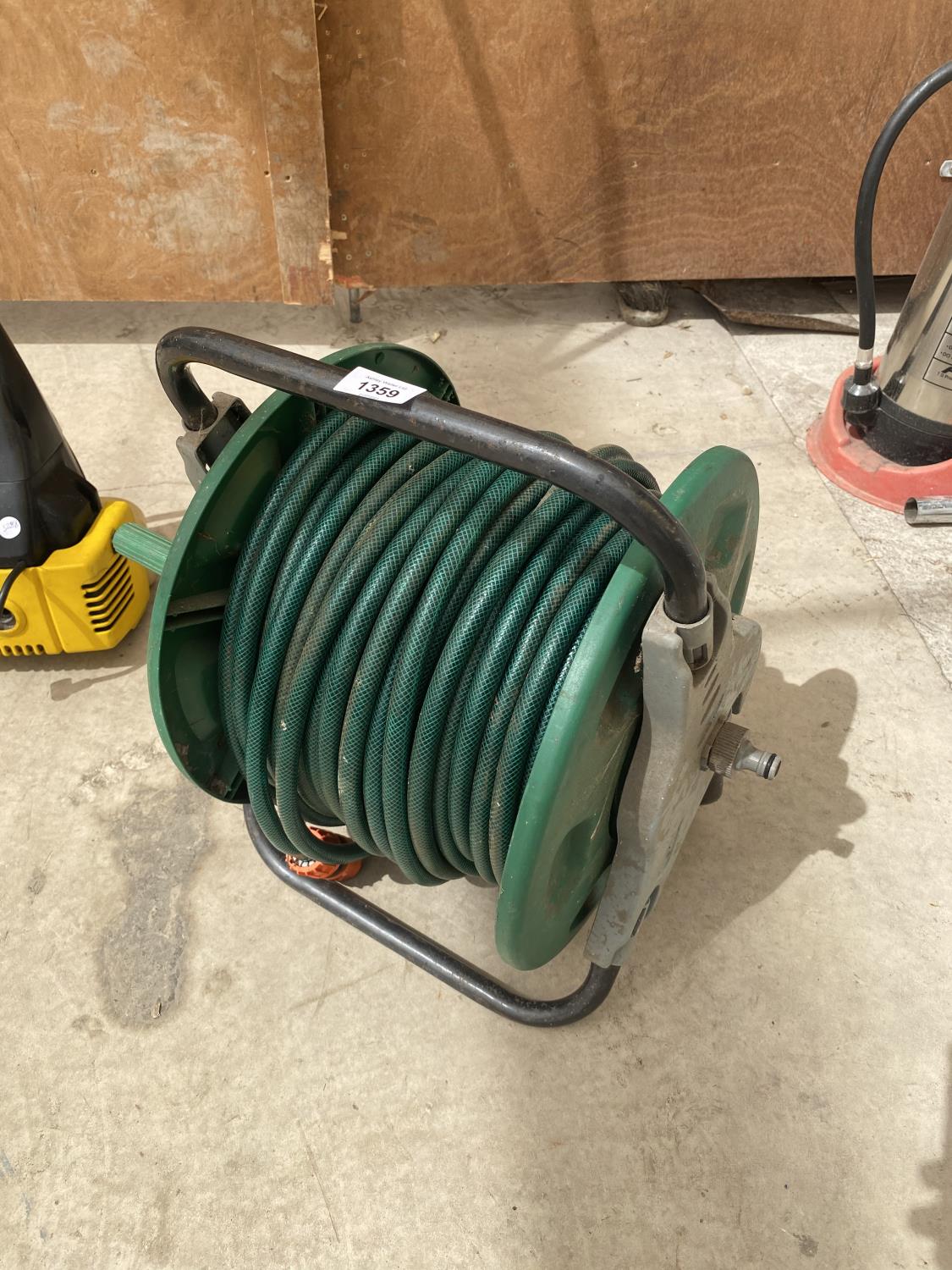 TWO GARDEN RAKES AND A HOSE REEL