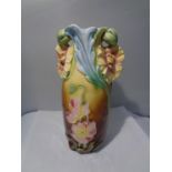 A DECORATIVE VASE WITH FLOWER DESIGN