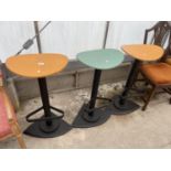 THREE MODERN KITCHEN STOOLS WITH OVAL COLOURED DISHED SEATS ON BLACK PAINTED METAL COLUMNS WITH FOOT