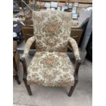 A MODERN FIRESIDE CHAIR STAMPED 'THE THOMAS GLENISTER COMPANY, HIGH WYCOMBE'