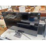 A SAMSUNG 49" TELEVISION WITH REMOTE CONTROL
