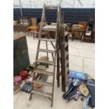 A VINTAGE SIX RUNG WOODEN STEP LADDER AND A FURTHER SIX RUNG WOODEN STEP LADDER