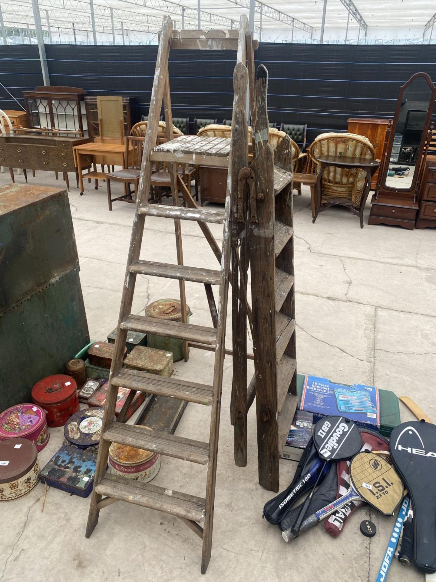 A VINTAGE SIX RUNG WOODEN STEP LADDER AND A FURTHER SIX RUNG WOODEN STEP LADDER