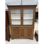 AN OAK BOOKCASE CABINET WITH TWO UPPER GLAZED DOORS AND THREE LOWER DOORS