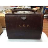 A VINTAGE LEATHER MONOGRAMMED CARRY BAG