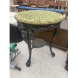 A HEAVY CAST IRON TABLE BASE WITH LIONS PAW FEET AND A DECORATIVE CAST TABLE TOP