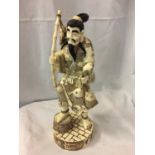 A TALL CARVED BONE JAPANESE MAN FIGURINE