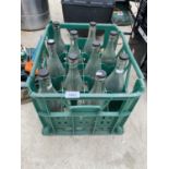 A BOTTLE CRATE CONTAINING TEN VINTAGE GLASS LUCOZADE BOTTLES