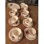 A ROSE DESIGN TEA SET CONSISTING OF SIX TRIOS