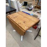 A MODERN PINE DROP LEAF TABLE ON PAINTED BASE