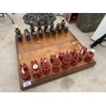 AN UNUSUAL CHESS SET WITH ORIENTAL DESIGN AND A WOODEN CHESS BOARD