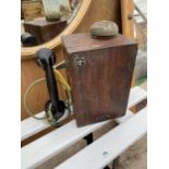 A VINTAGE WOODEN CASED WALL MOUNTED TELEPHONE (S.T.C)