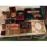 A LARGE QUANTITY OF GAMES TO INCLUDE SCRABBLE, A VINTAGE RUBICS CUBE, DOMINOES, PLAYING CARDS,